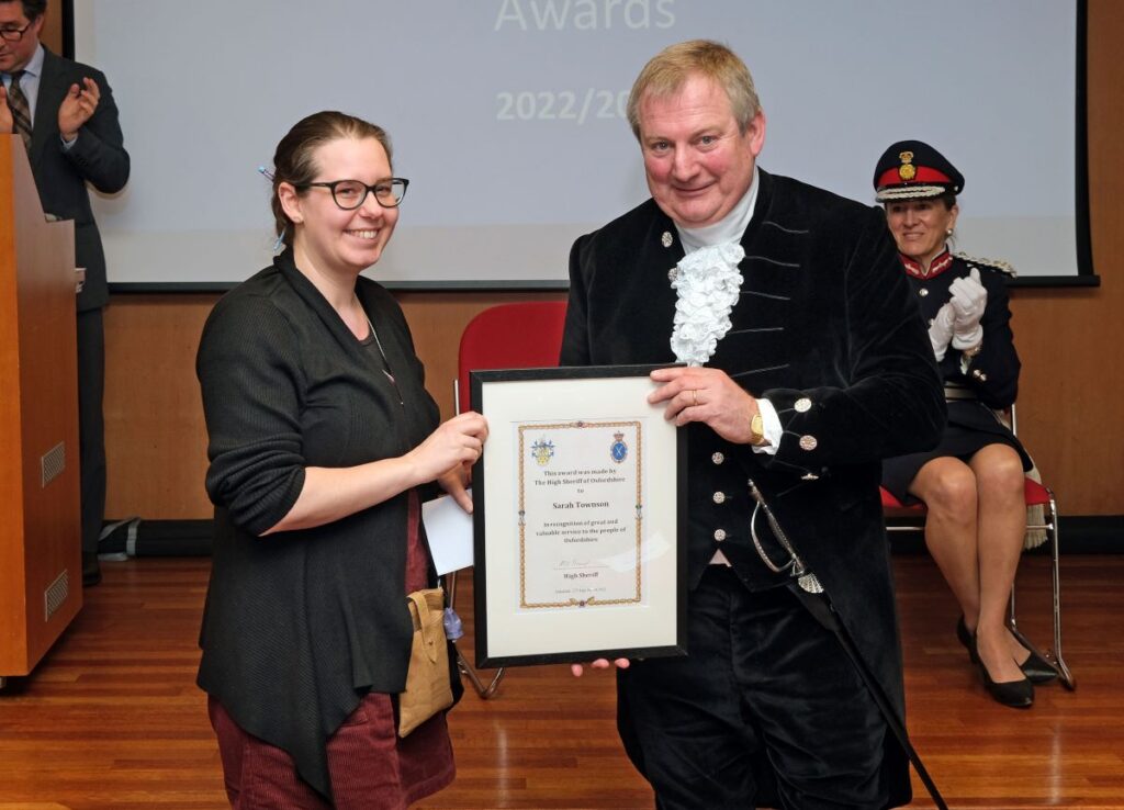Sarah and High Sheriff of Oxfordshire, Mark Beard, posing with award certificate.
