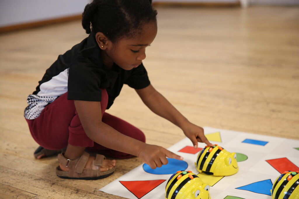 Child experiments with bee shaped Bee-bots