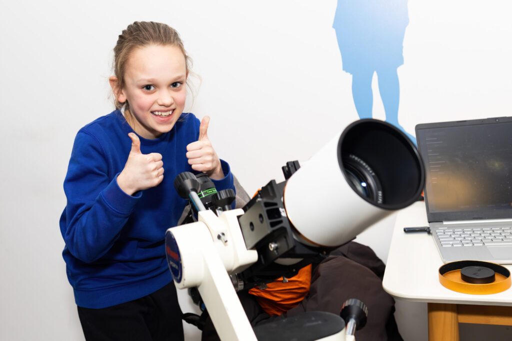 child with telescope