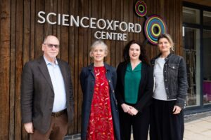 four adults in front of building with Science Oxford Centre logo